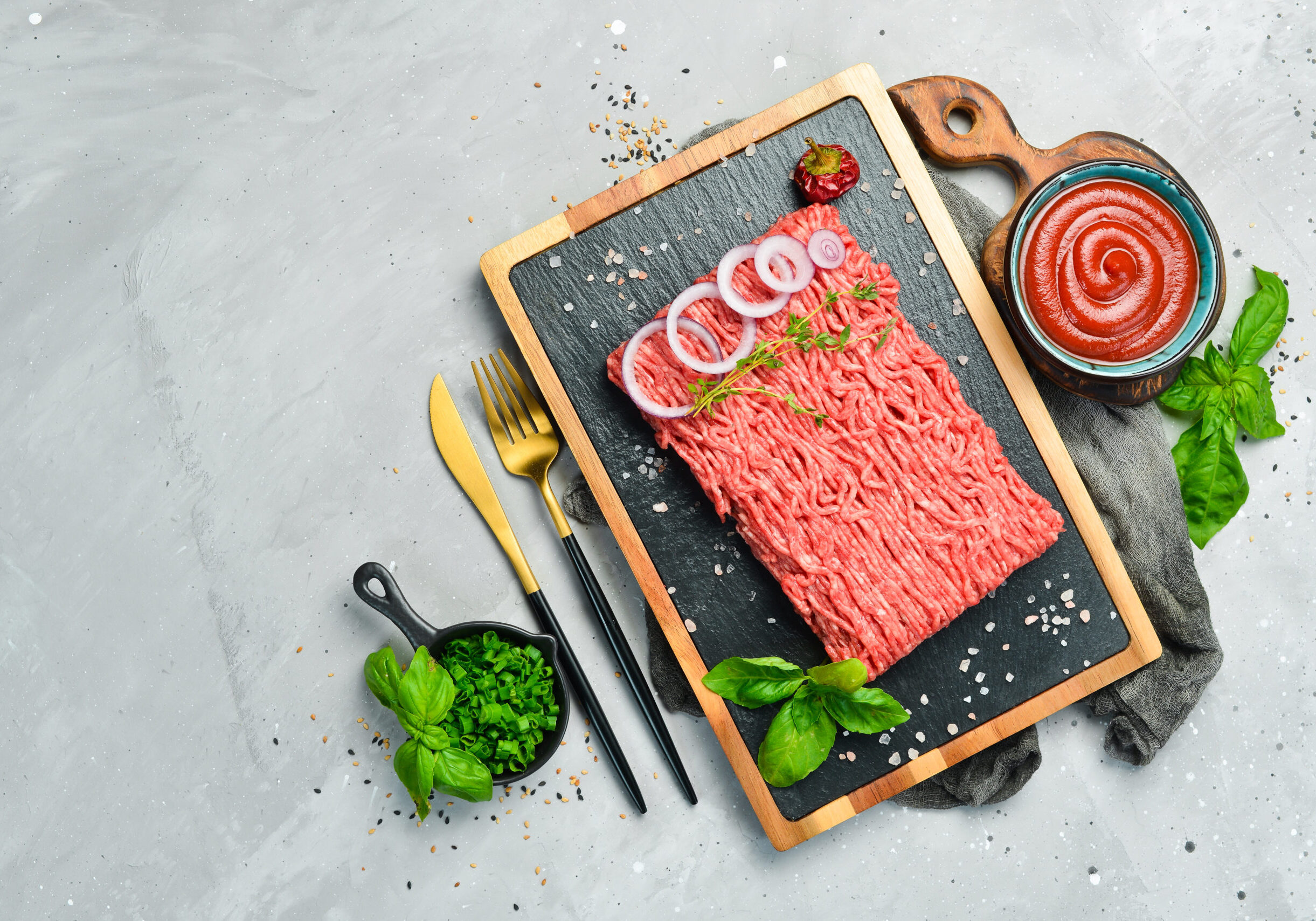 Meat Fresh ground minced beef on a plate Preparation of cutlets Top view On a stone background